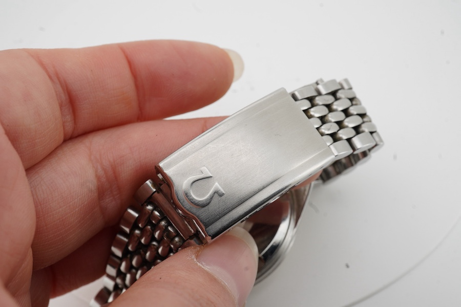 A gentleman's 1964 stainless steel Omega Seamaster Automatic wrist watch, with baton numerals and date aperture, movement 562, case diameter 35mm, on a stainless steel Omega bracelet, with Omega zip up pouch, no papers.